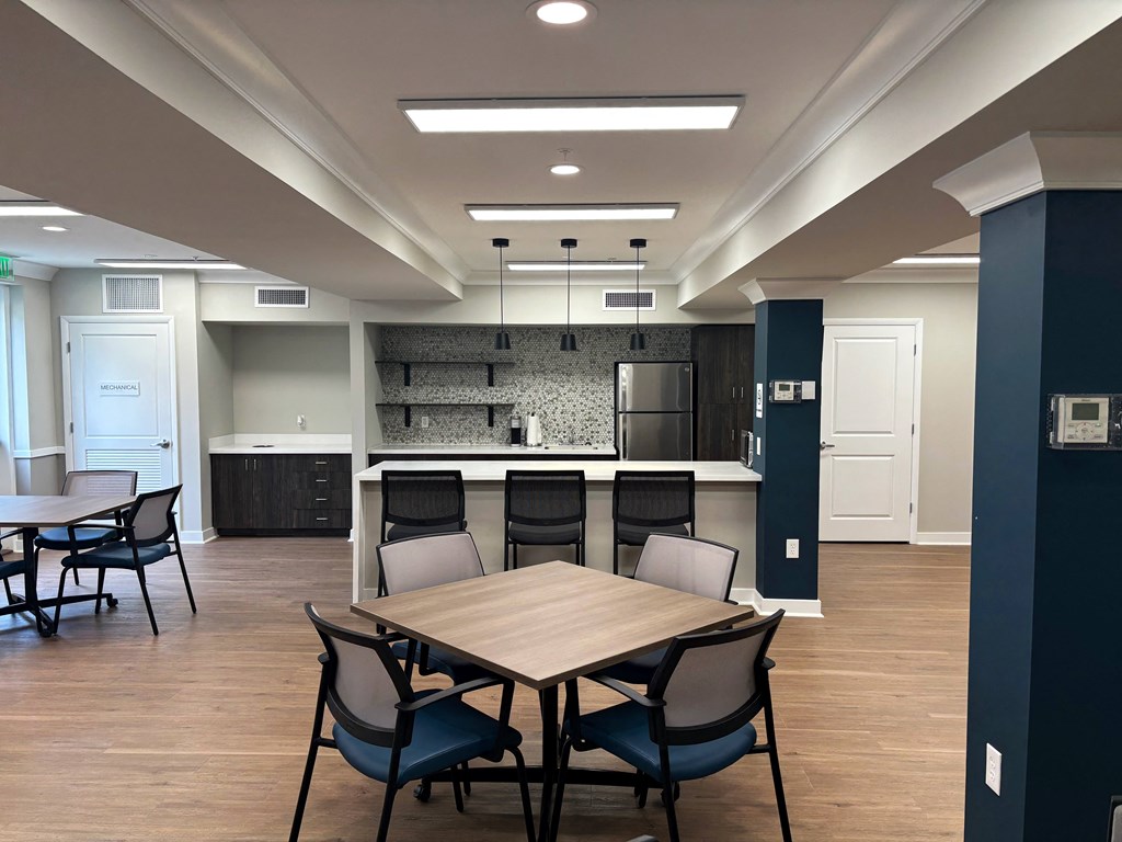 a dining room with a table and chairs and a kitchen