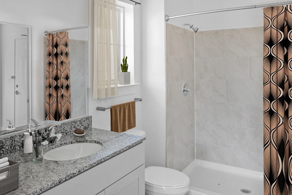 a bathroom with a shower and a sink and a toilet