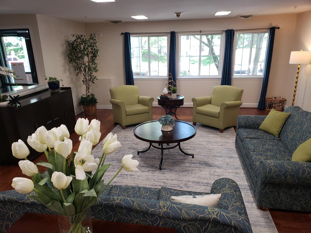 a living room with couches chairs and a coffee table