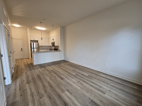 A kitchen area with a stainless steel refrigerator and a countertop.