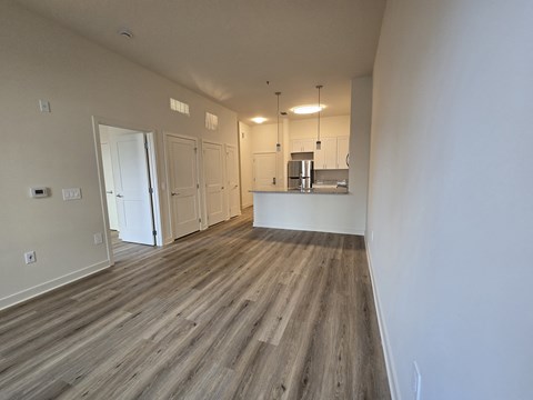 A room with wooden flooring and white walls.
