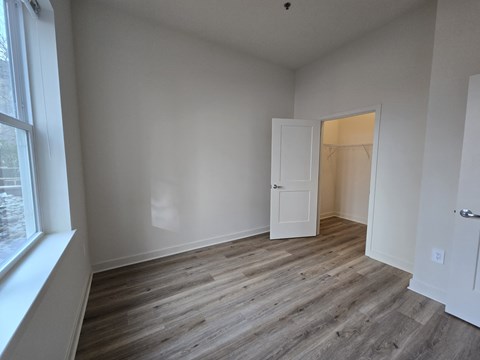 A room with a wooden floor and white walls.
