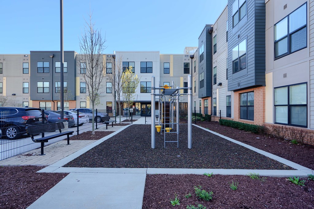 A modern courtyard surrounded by apartment buildings.