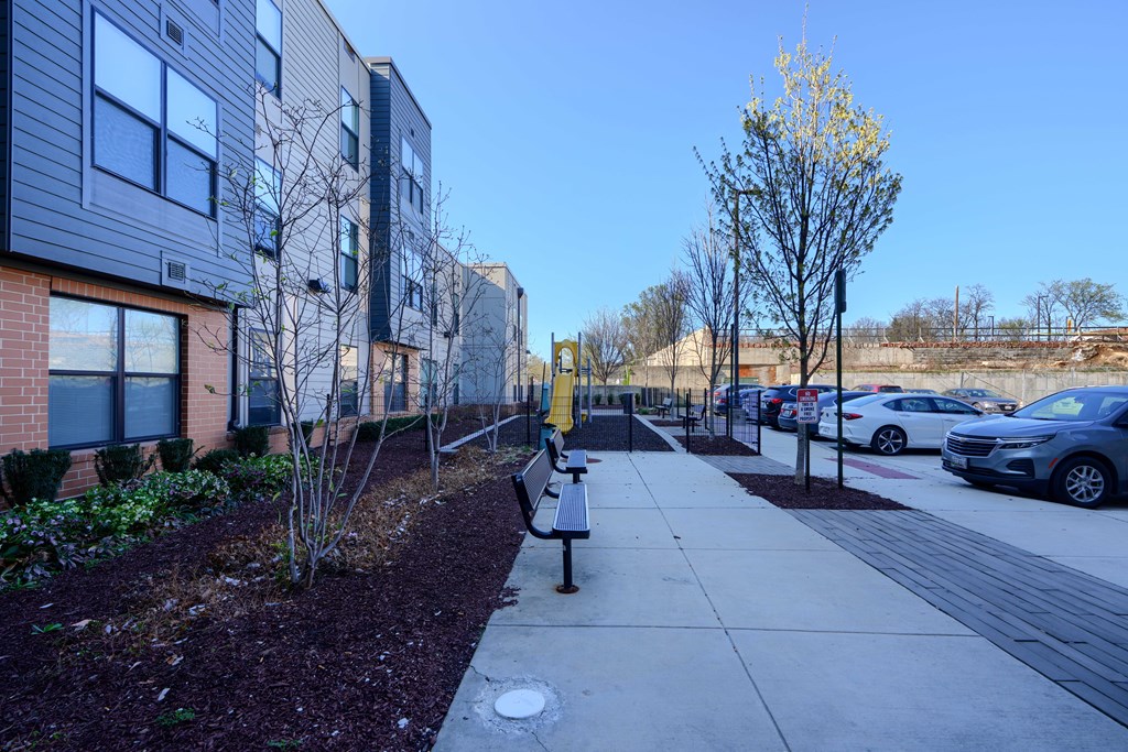 A residential area with apartment buildings and parked cars.