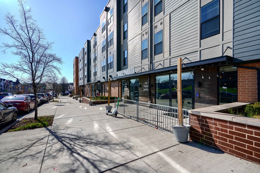 A modern building with a parking lot in front.