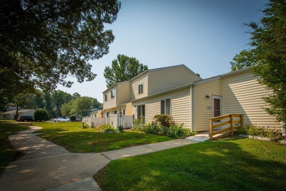 a row of houses with a sidewalk in front of them