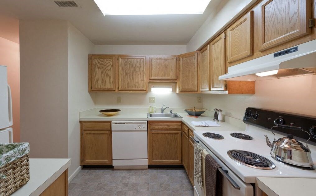 a kitchen with wooden cabinets and white appliances