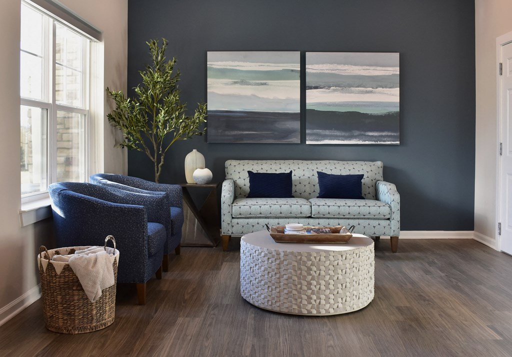 a common area space with couches and chairs and a table