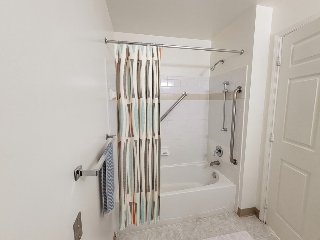 a bathroom with a tub and shower and a shower curtain