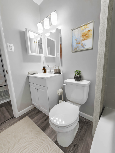 a bathroom with a toilet sink and bathtub in a 555 waverly unit