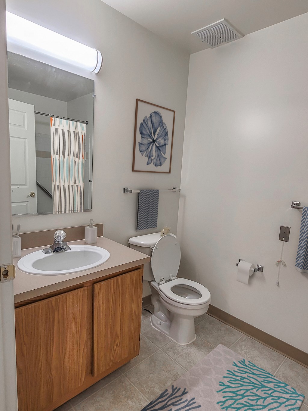 an empty bathroom with a sink toilet and mirror
