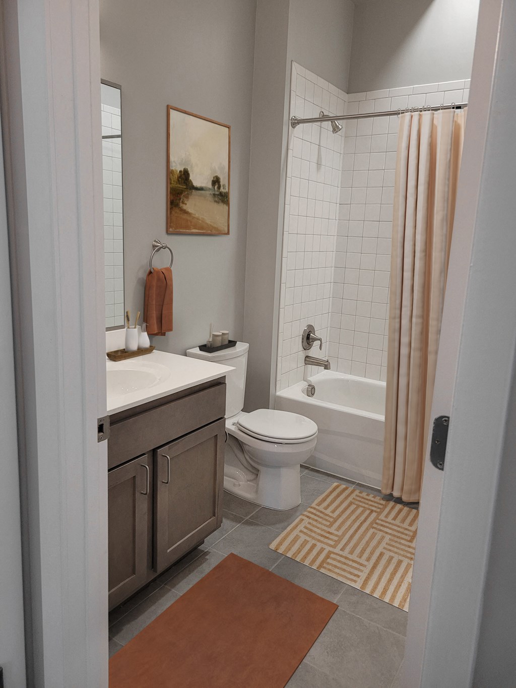 a bathroom with a toilet and a sink and a shower