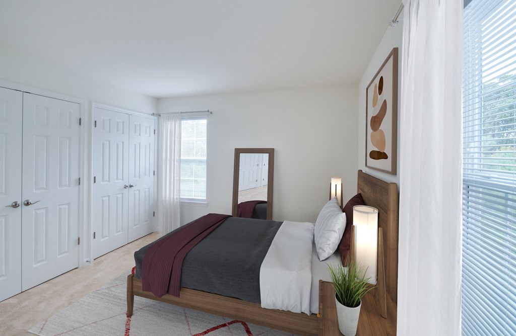 a bedroom with white walls and a bed with a wooden frame