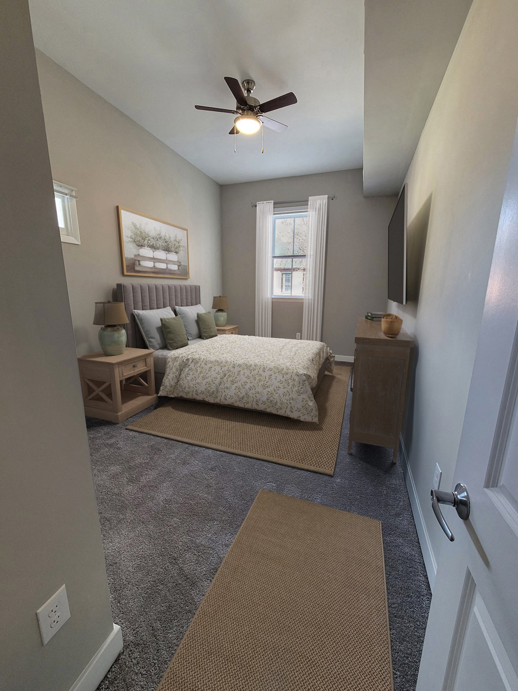 a bedroom with a bed and a ceiling fan