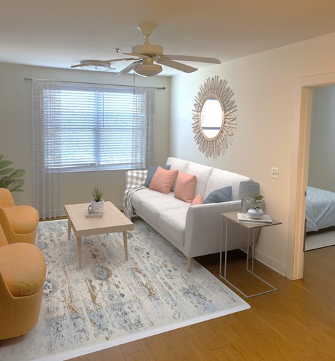 A living room with a white couch, a yellow chair, and a rug.
