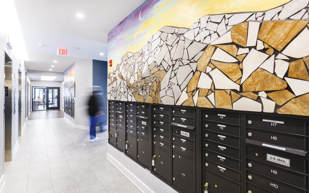 a painting of a rocky landscape hangs on the wall of a school hallway