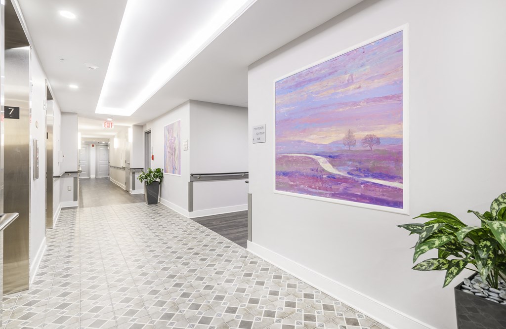 a hallway with a large painting on the wall