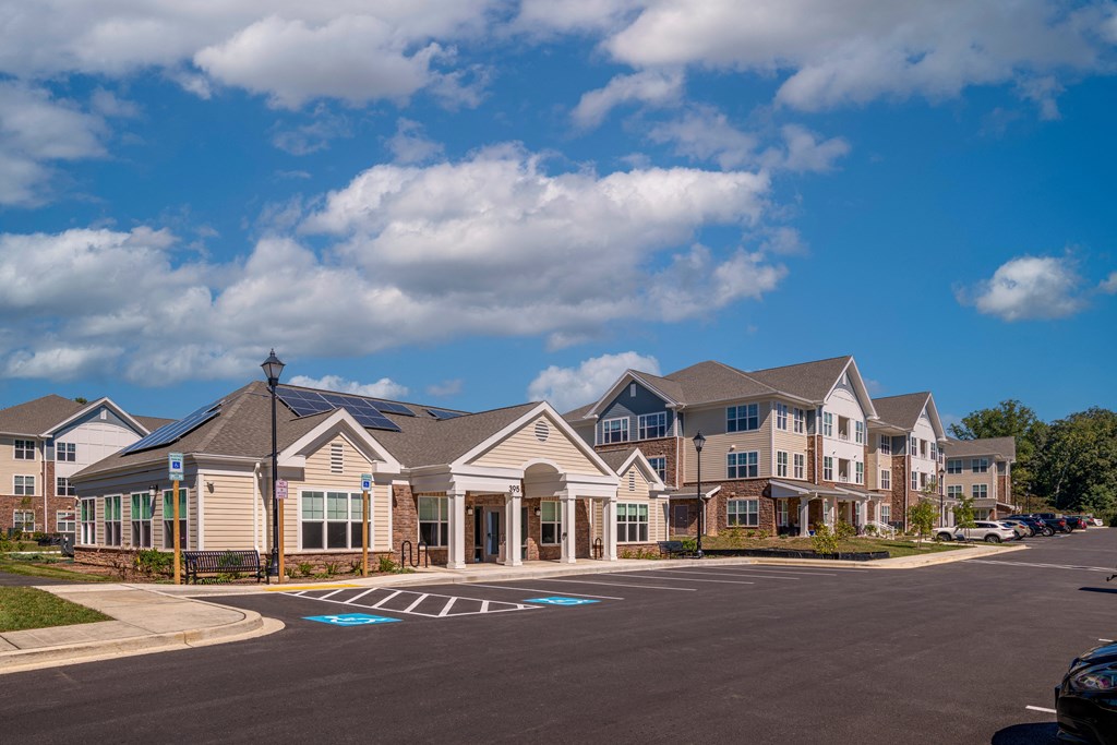 an empty parking lot in front of a row of houses