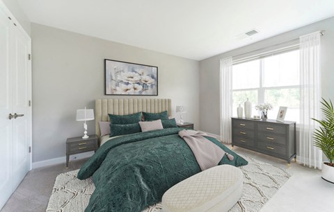 a bedroom with a bed and a dresser and a window