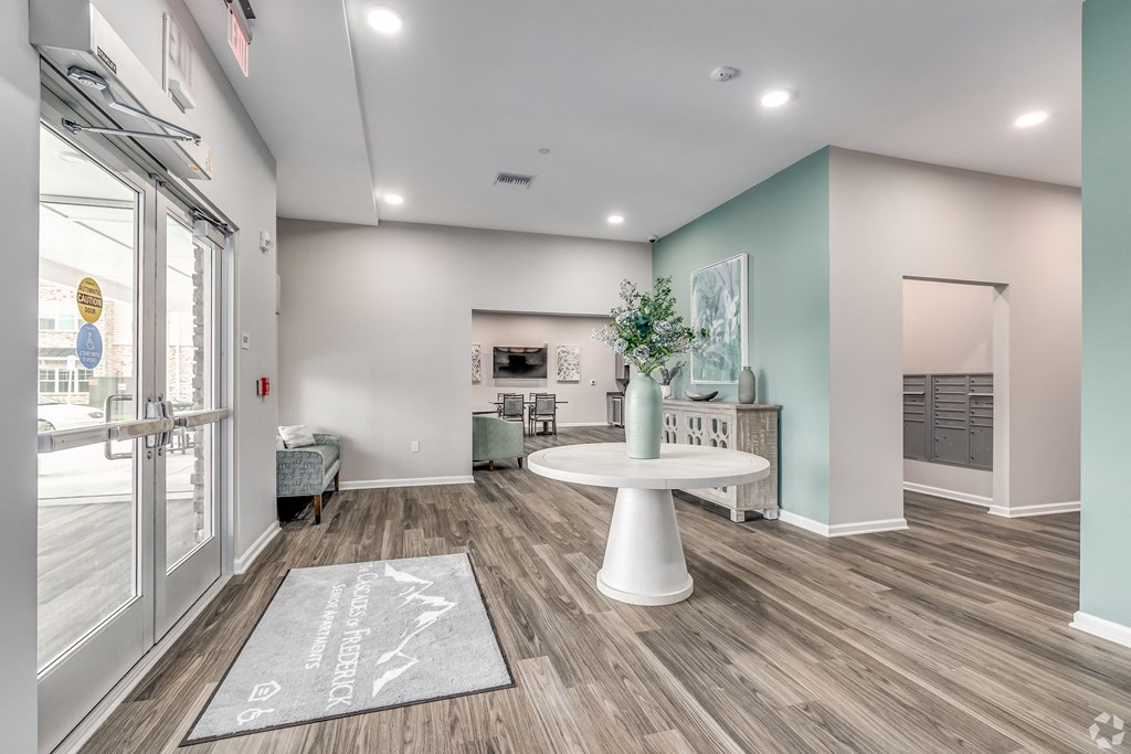 a living room with a white table and a glass door