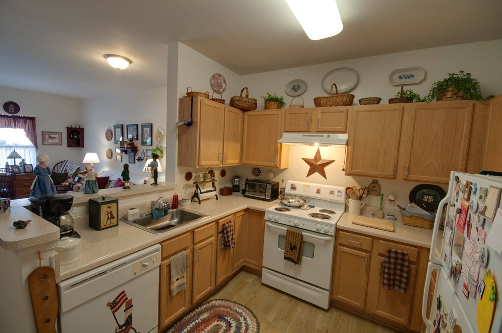 a kitchen with white appliances and wooden cabinets
