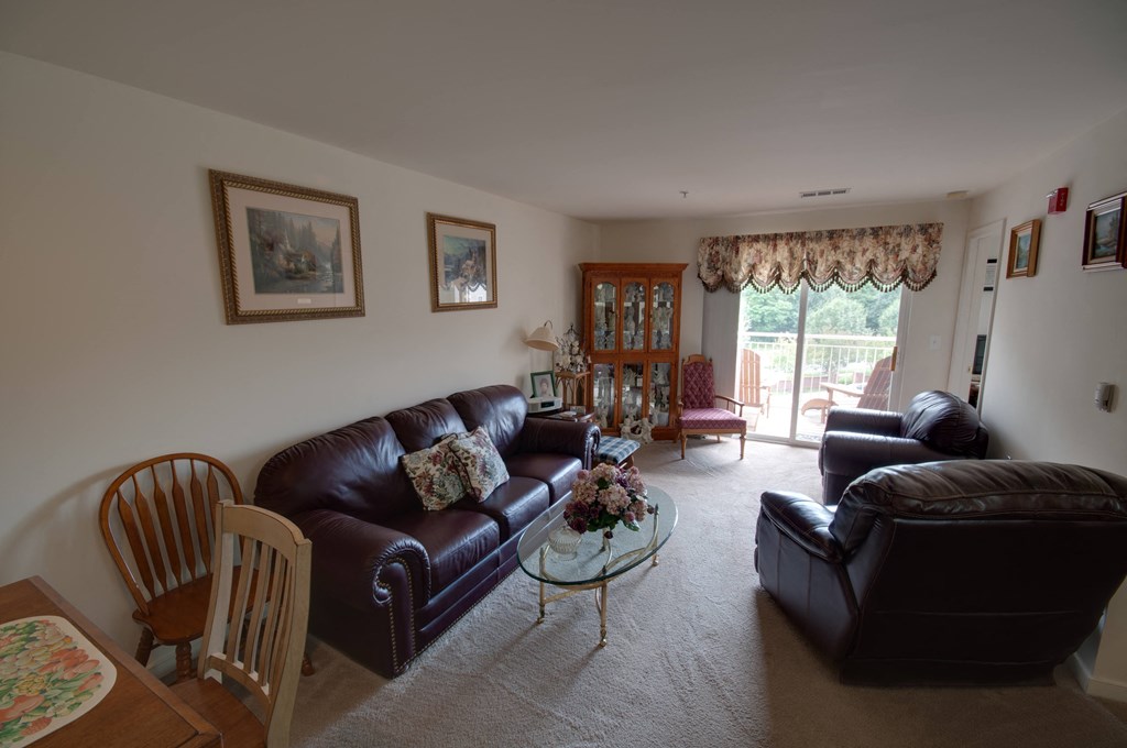 a view of a living room with couches and a table