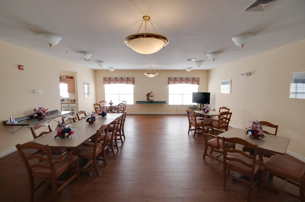 a dining room with tables and chairs in a multipurpose room