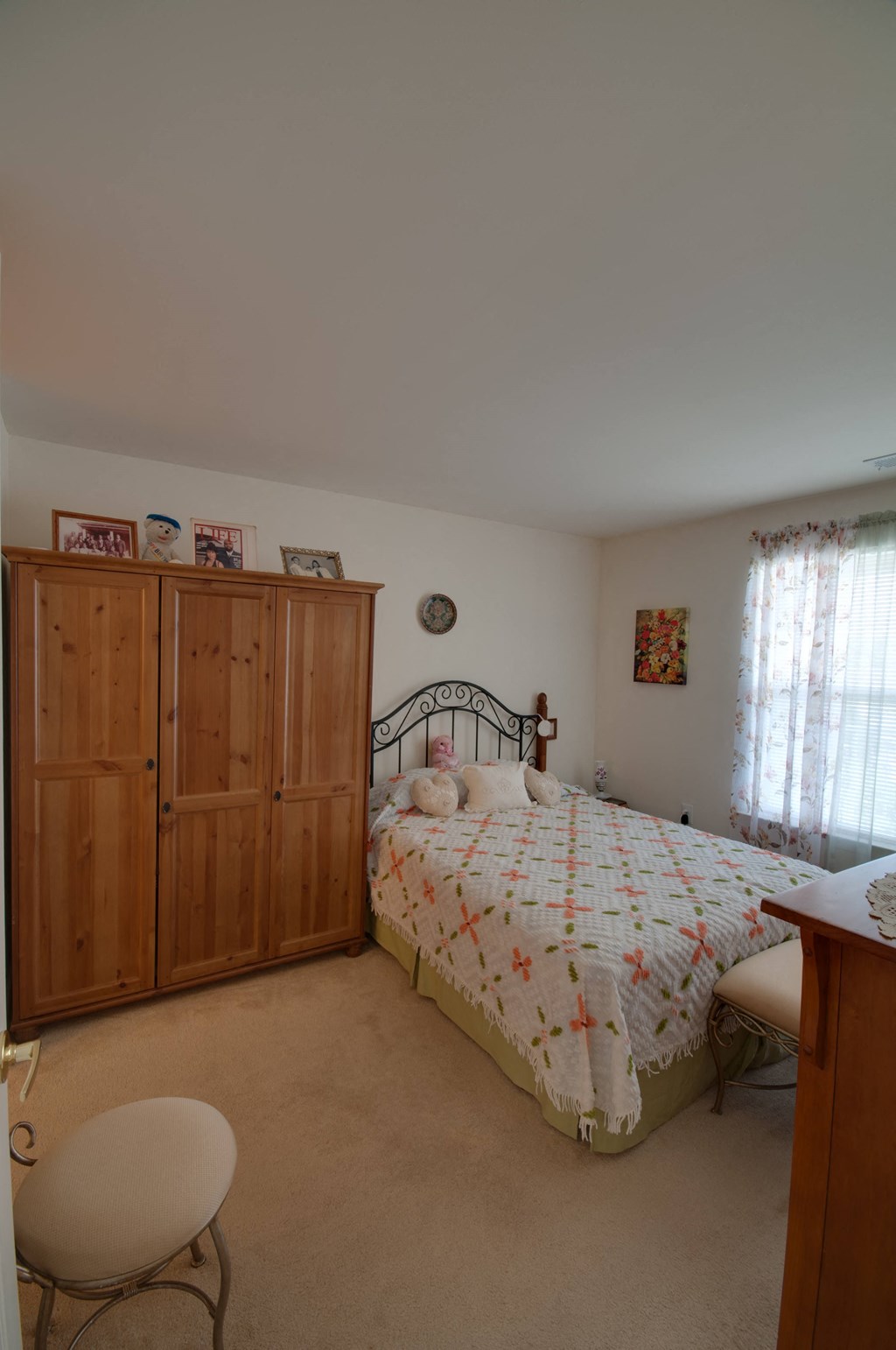 a bedroom with a bed and a dresser