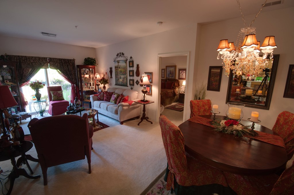 a dining room and living room with a table and chairs
