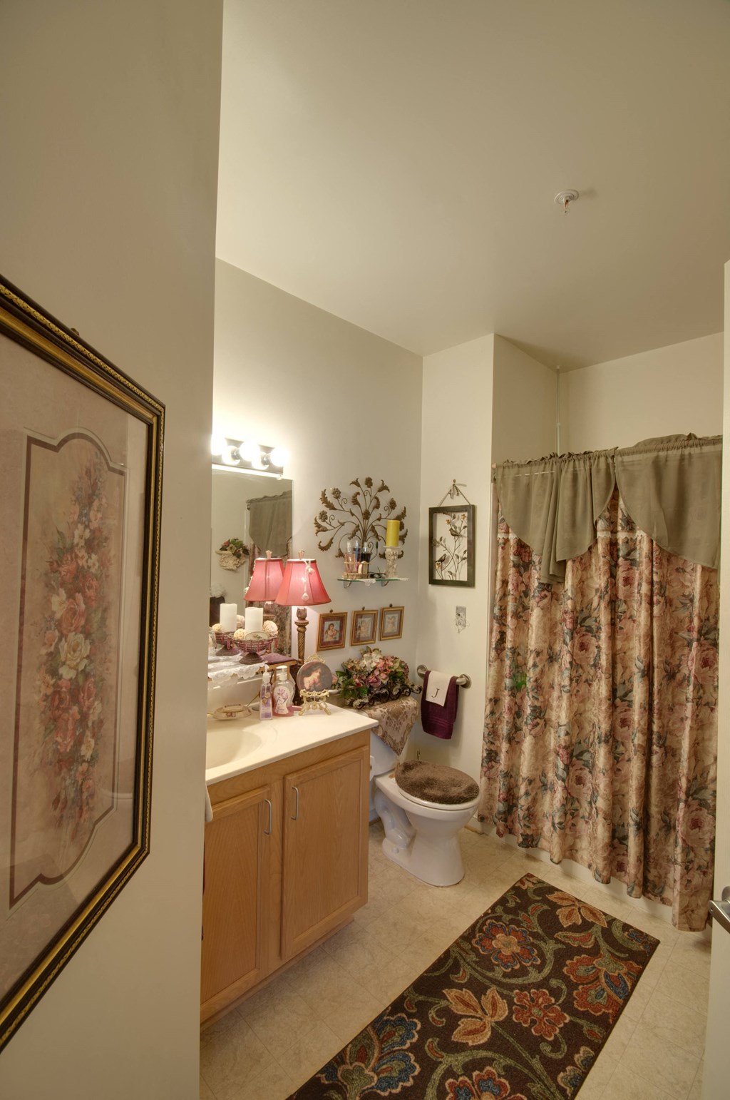 a bathroom with a shower curtain and a toilet and sink