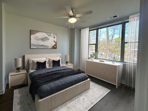 A bedroom with a large bed and a painting on the wall.