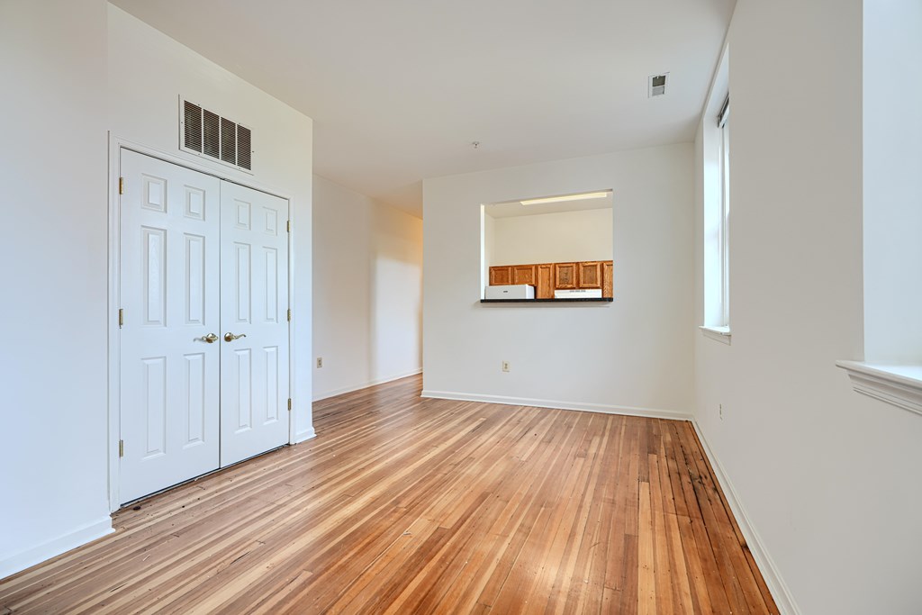 A room with wooden floors and white walls.