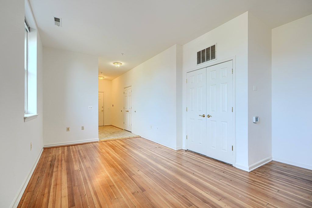 A room with wooden floors and white walls.