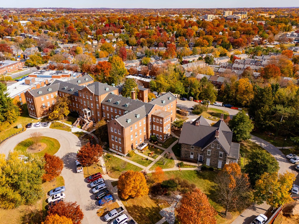 An aerial view of a campus with a large building in the center.