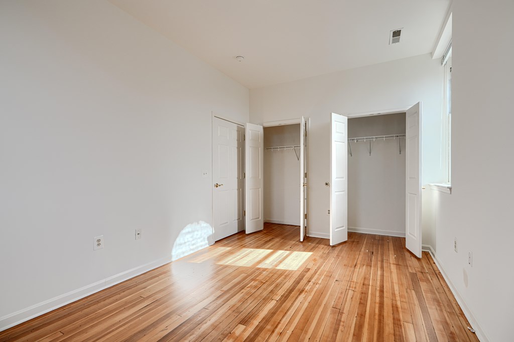 A room with wooden floors and white walls.