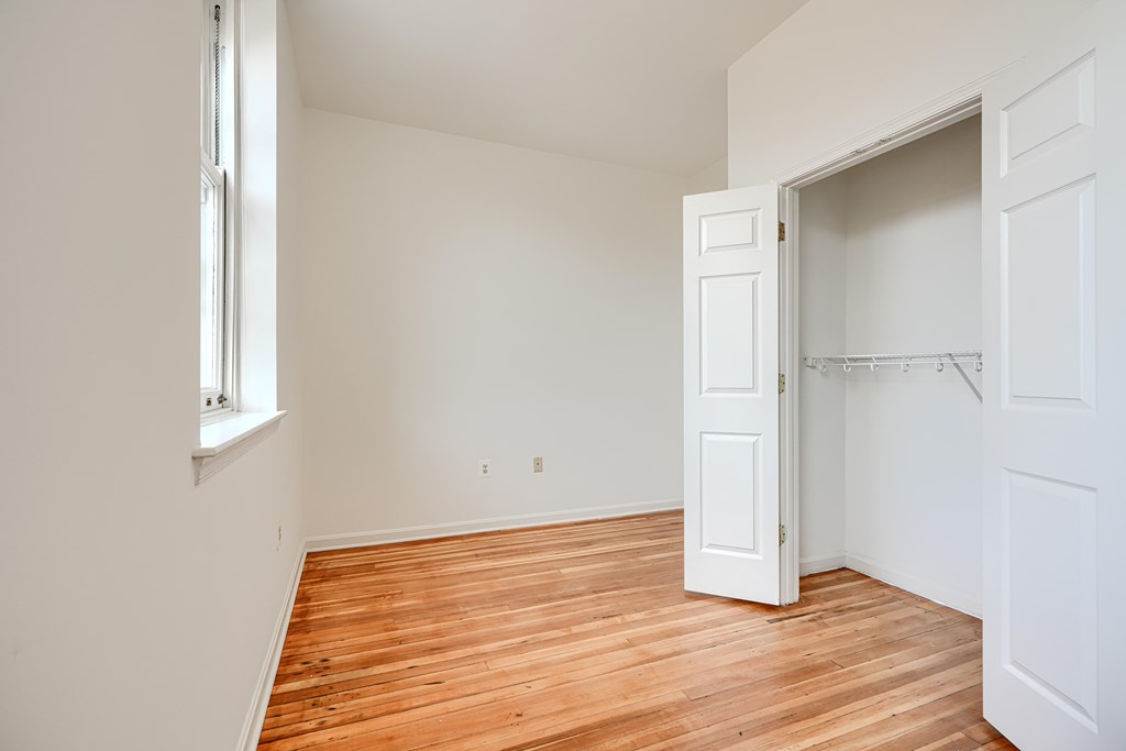 A room with a white door and a window.