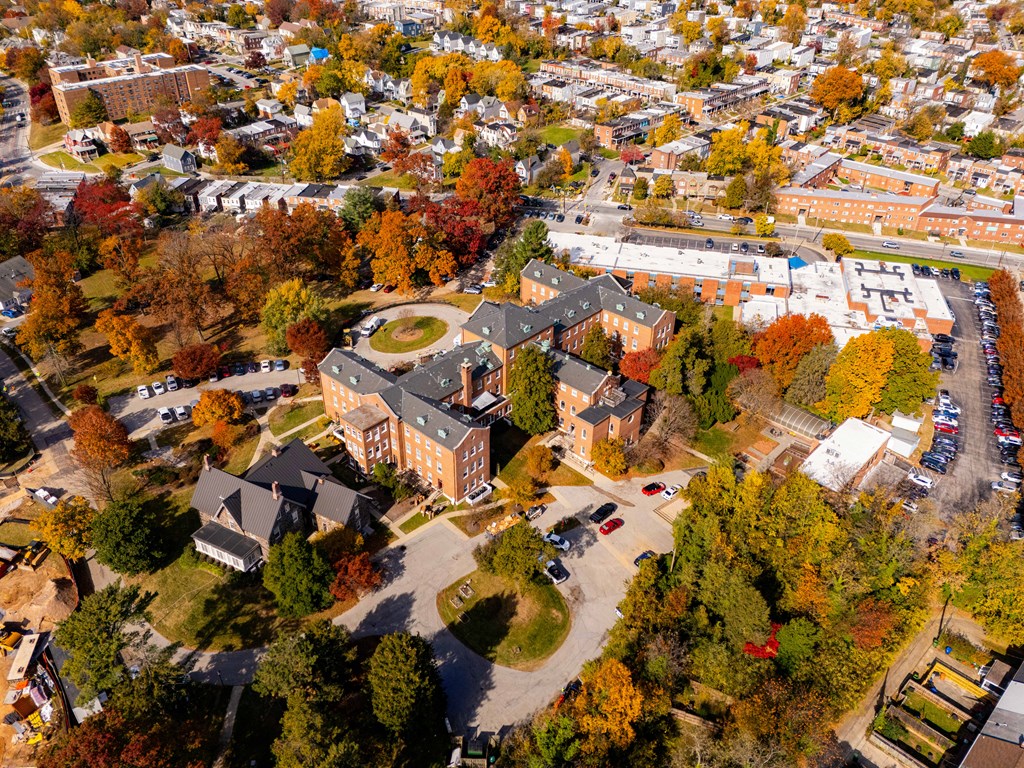 An aerial view of a campus with a large building in the center.