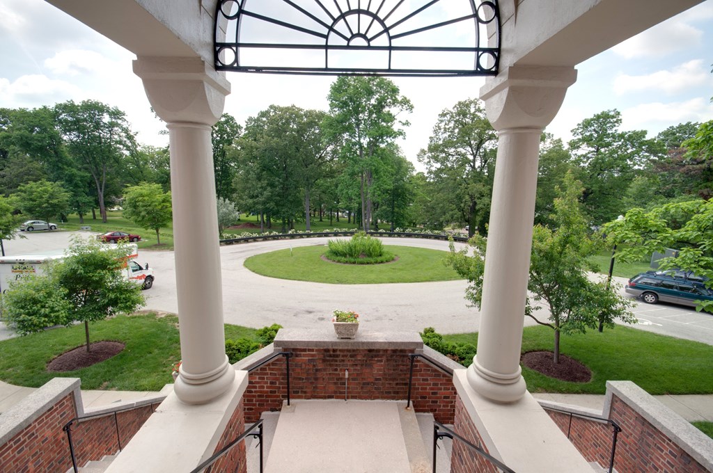 A view of a courtyard from a second floor balcony.