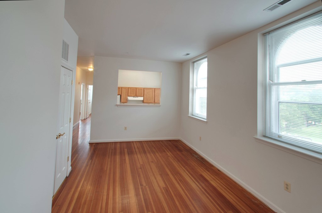 A room with wooden floors and white walls.