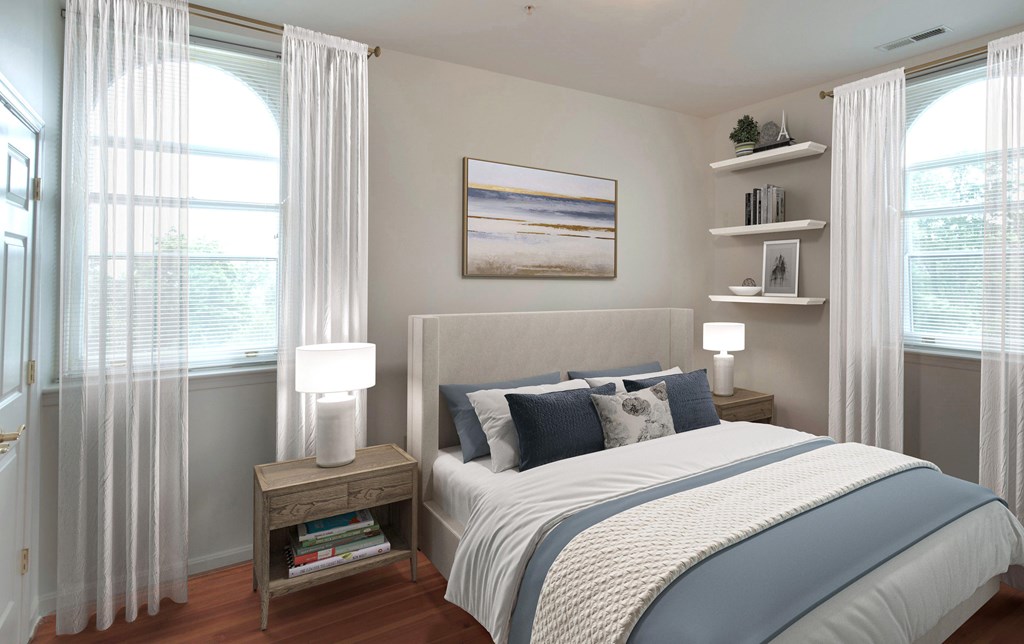 A bedroom with a large bed and a painting on the wall.