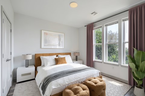 A bedroom with a large bed and a painting on the wall.