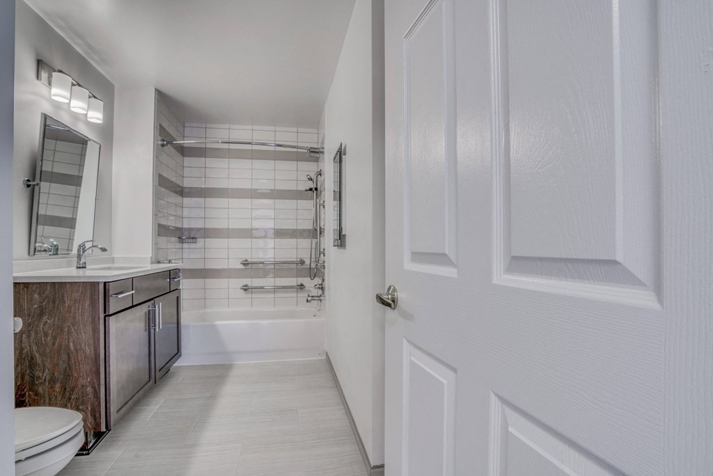 a bathroom with a shower and a sink and a toilet