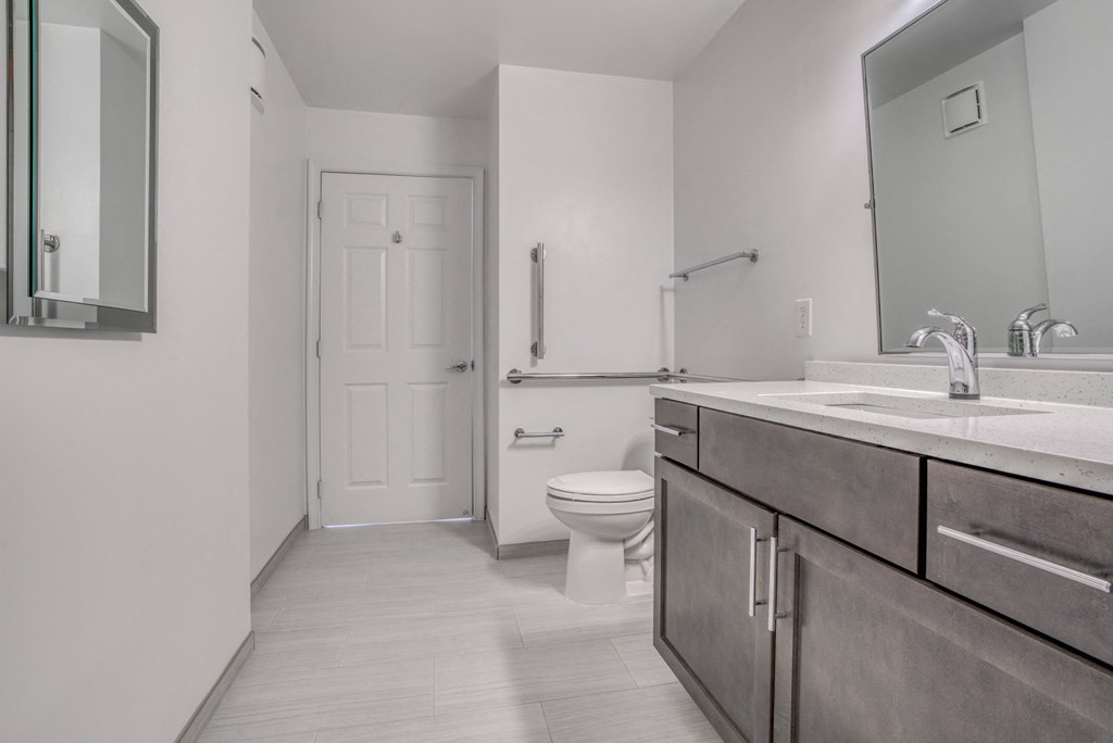 a bathroom with a toilet and a sink and a mirror