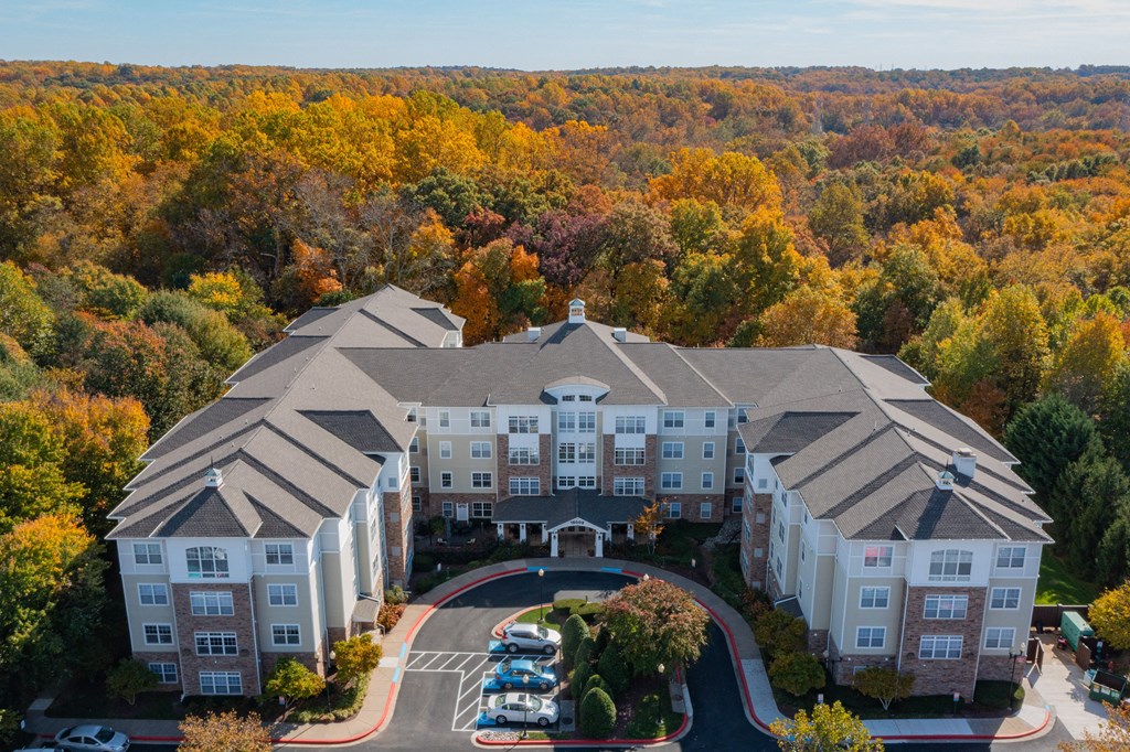 an aerial view of a large building surrounded by trees