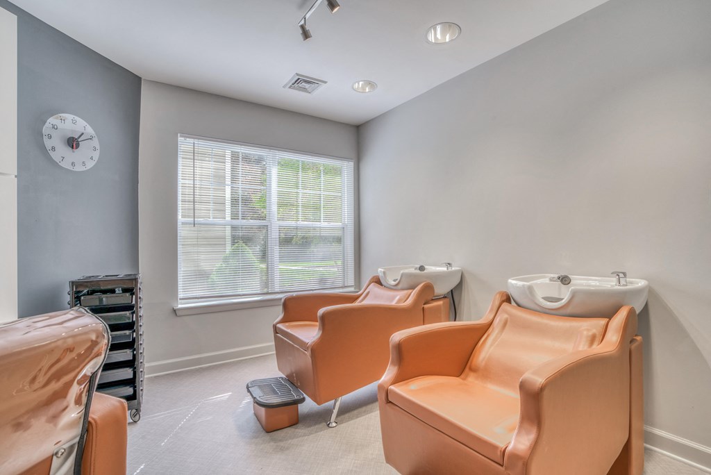 a dental room with four chairs and a sink and a window