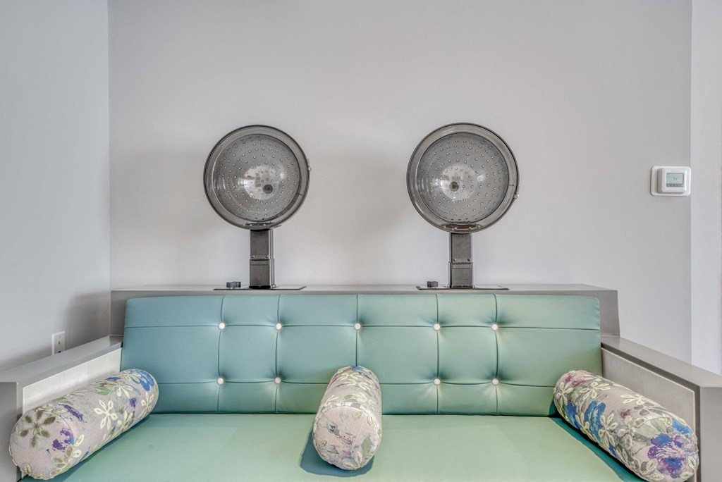 two fans above a couch in a room