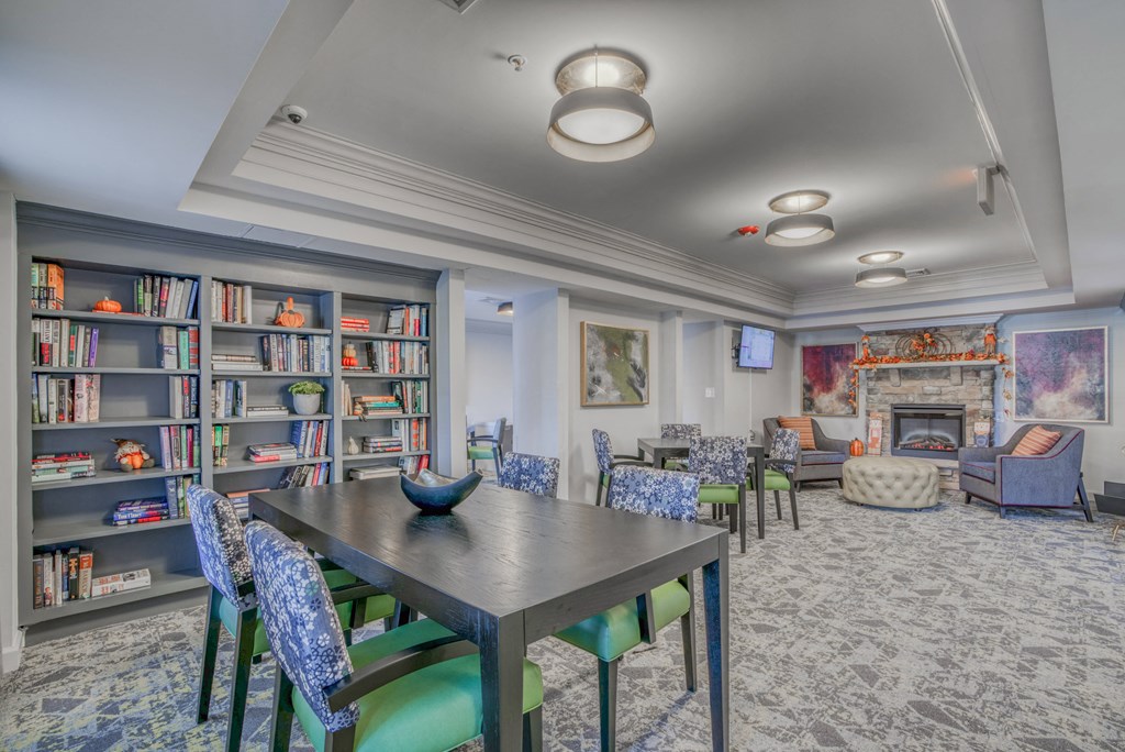 a dining room with a table and chairs and a library