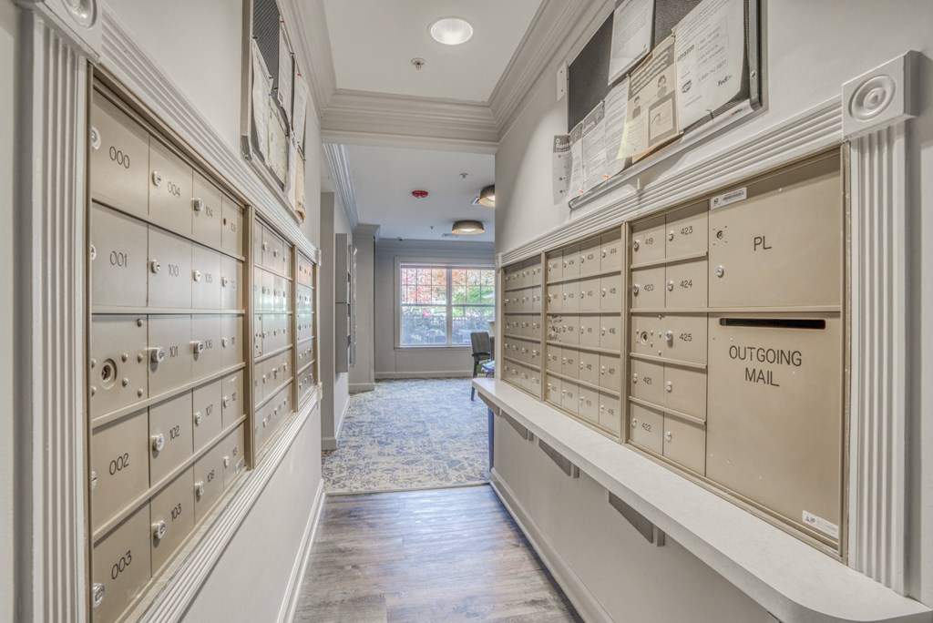 the locker room at the end of a hallway with rows of lockers