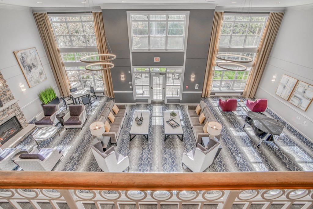 a view of a living room from the second floor of a hotel
