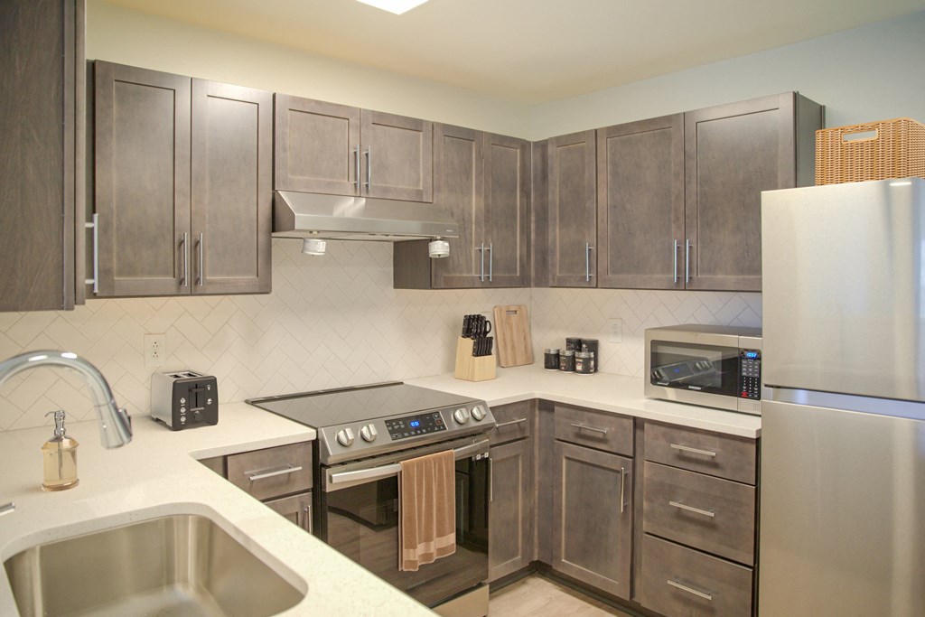 a kitchen with stainless steel appliances and wooden cabinets